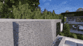 a waterfall is behind a brick wall in front of a house