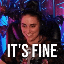 a woman wearing headphones is sitting in a chair with the words `` it 's fine '' written on her face .