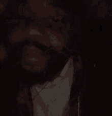 a man with a beard is wearing headphones in the dark .