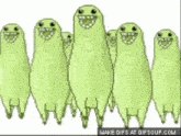 a group of green ghosts are smiling and standing next to each other .