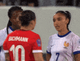a female soccer player wearing a red jersey with the number 10 on it