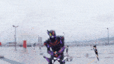 a person in a purple and black costume is standing in a parking lot holding a sword .