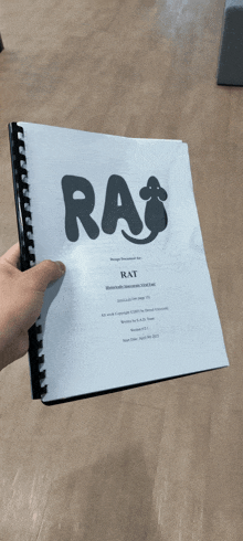 a person is holding a book titled rat
