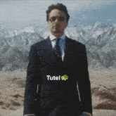a man in a suit and tie stands in front of mountains with the word tutel written on the bottom