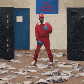 a man in a red suit is standing in front of a sign that says no glass taffing