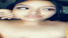 a woman without a shirt is making a funny face with her tongue out