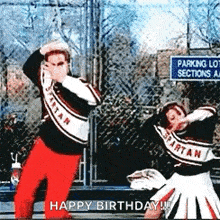 two spartans cheerleaders are dancing in front of a parking lot sign .
