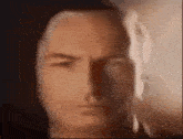 a close up of a man 's face with a shadow on it .