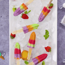 a white plate topped with colorful popsicles and ice