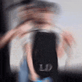 a blurry image of a person with the letter l on their back