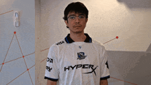 a man wearing a white shirt that says hyper x