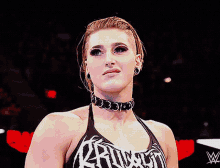 a woman wearing a choker and a tank top that says ruthless
