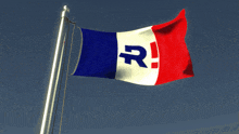 a flag with the letter r on it is waving in the wind