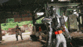 a man in a silver armor stands in front of a sign that says ' safety ' on it