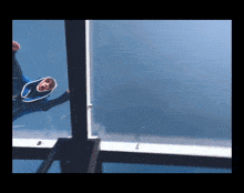 a person in a blue suit is swimming in a blue pool