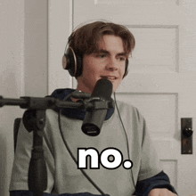 a man wearing headphones and a shirt that says no on it