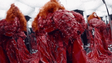 a woman with red hair is standing in front of a mirror