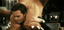 a man is hugging a stuffed animal in a room .