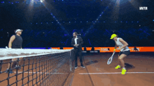 two tennis players on a court with a wta logo on the bottom