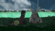 a man and a rabbit are sitting in the grass next to a body of water .