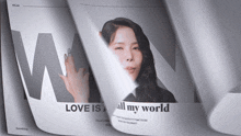 a newspaper with a picture of a woman and the headline love is all my world