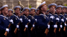 a group of soldiers marching in a parade with the word thomas on the bottom right