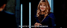 a woman in a superman costume is standing in a dark room and saying no rest for the world saving genius .