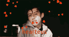a picture of a boy with hearts on his face and the words " hearteus " below him