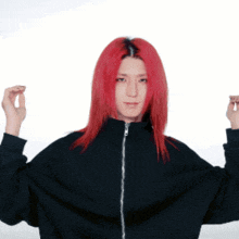 a woman with red hair is wearing a black jacket with a zipper