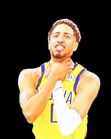 a basketball player in a yellow jersey with the letter l on the front
