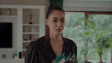 a woman is holding a bouquet of flowers in her hands