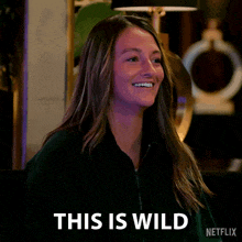 a woman is smiling and saying " this is wild " .