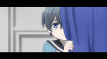a boy with blue eyes peeking out behind a blue curtain