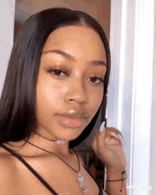the girl is wearing a choker necklace and bracelets .