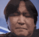 a close up of a man 's face with a sad look on his face
