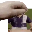 a hand is reaching out towards a man in a blue shirt and apron .