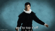 a man in a black jacket and white collar is saying and to top if off