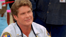 a man with a stethoscope around his neck is wearing a baywatch shirt