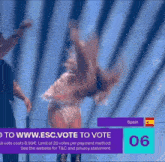 a woman dancing in front of a sign that says spain