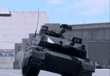 a military tank is driving down a road