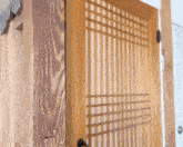 a close up of a wooden door with a metal handle