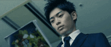 a man in a suit and tie is looking down