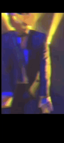 a blurry picture of a person in a blue shirt and tie