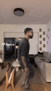 a man is dancing in a living room with a viggle.ai displayed