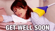 a woman is laying on a toilet with a broom on her back and the words get well soon