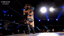 two women wrestling in a ring with the word stardom on the bottom right