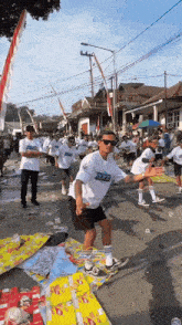 a man wearing a white shirt that says buzz