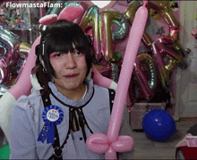 a girl with pink balloons and a happy boy pin