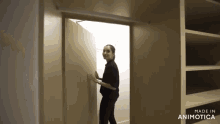 a woman opens a door in a closet made in animatica