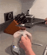 a person is cutting into a gallon of milk